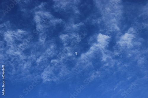 blue sky with clouds and moon