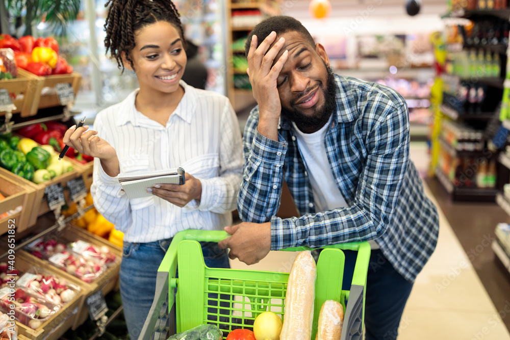 African Husband Waiting Wife Tired Of Grocery Shopping In Supermarket