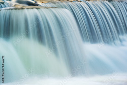 Landscape captured with blurred motion of a cascade on the Rabbit River, Michigan, USA