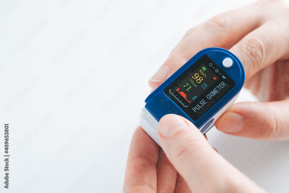 Pulse Oximeter finger digital device to measure oxygen saturation in blood.  Stock Photo | Adobe Stock