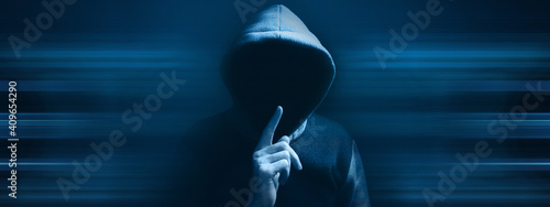 Photos hooded man making silence gesture