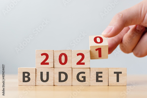 Change annual year 2020 to 2021 budget financial management concept. Wooden cube block with word BUDGET