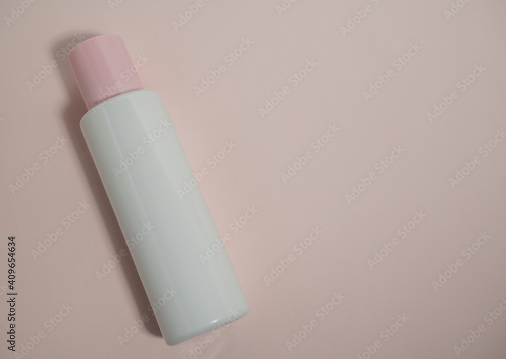 An empty white plastic bottle made of decomposing material with a pink lid on a pink background. Packaging of cream, body lotion, gel, facial foam or skin care products. An empty white plastic bottle made of decomposing material with a pink lid on a pink background. Packaging of cream, body lotion, gel, facial foam or skin care products.