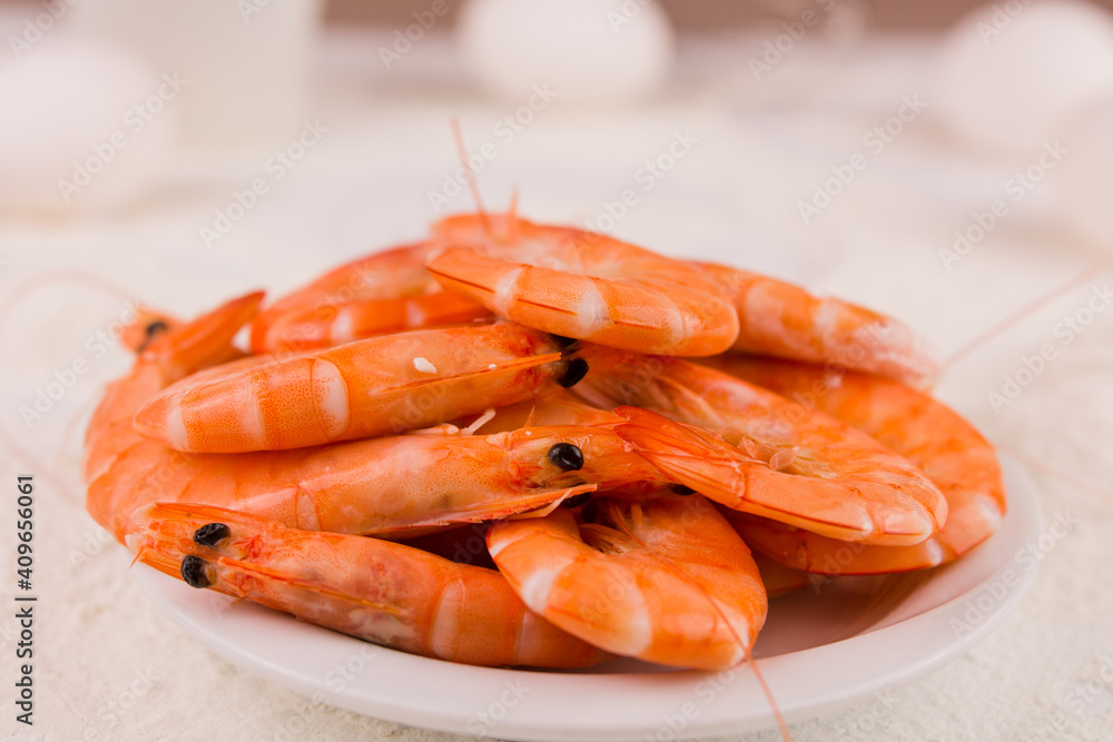 beautiful large boiled tiger prawns on a white plate on the kitchen table beautiful large boiled tiger prawns on a white plate on the kitchen table