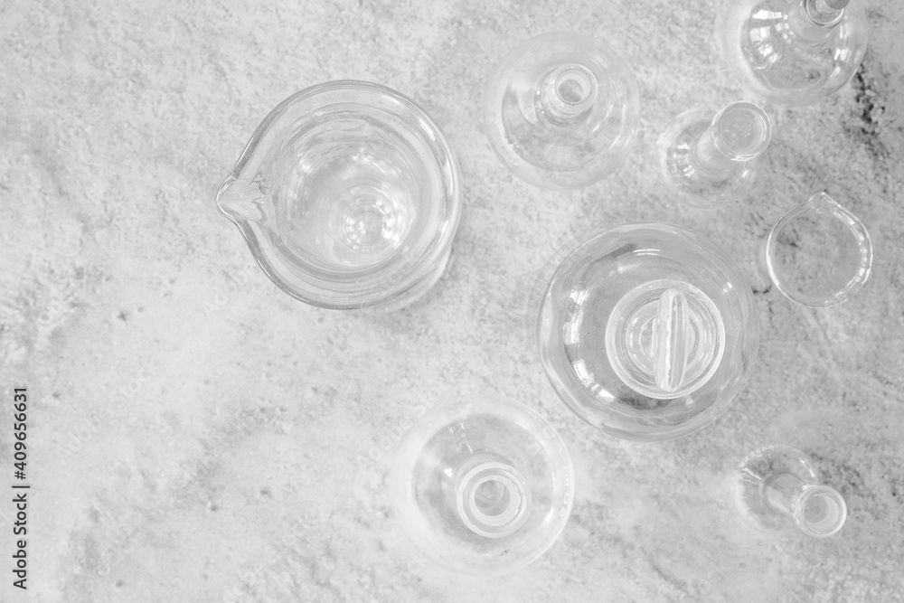 Antique laboratory glassware flat lay on granite surface black and white with negative space for copy Antique laboratory glassware flat lay on granite surface black and white with negative space for copy