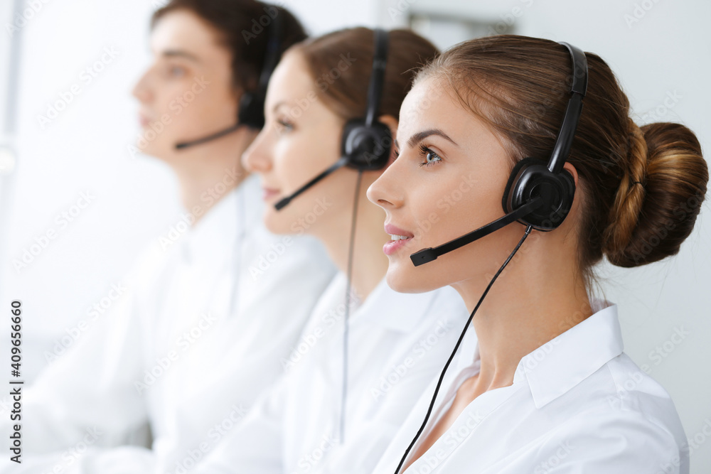 Call center. Beautiful young woman using headset and computer to help customers. Business concept Call center. Beautiful young woman using headset and computer to help customers. Business concept