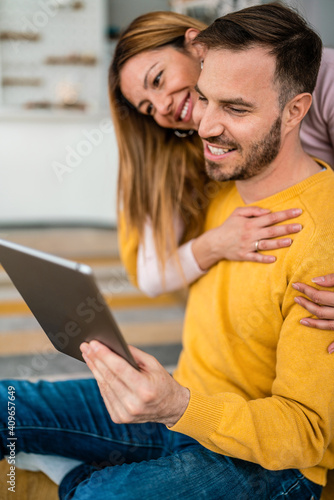 Young couple in love at home websurfing on internet