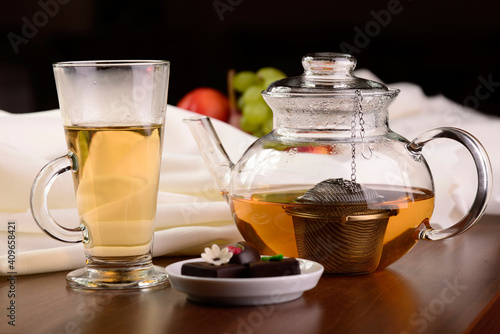 Glass teapot and mug on the wooden background