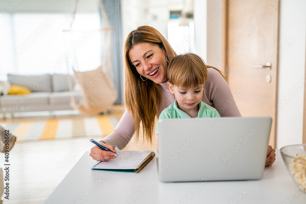 Businesswoman mother woman with a toddler working at the computer at home Businesswoman mother woman with a toddler working at the computer at home