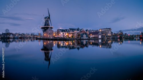 Windmill De Adriaan along the river Spaarne in Haarlem at blue hour.