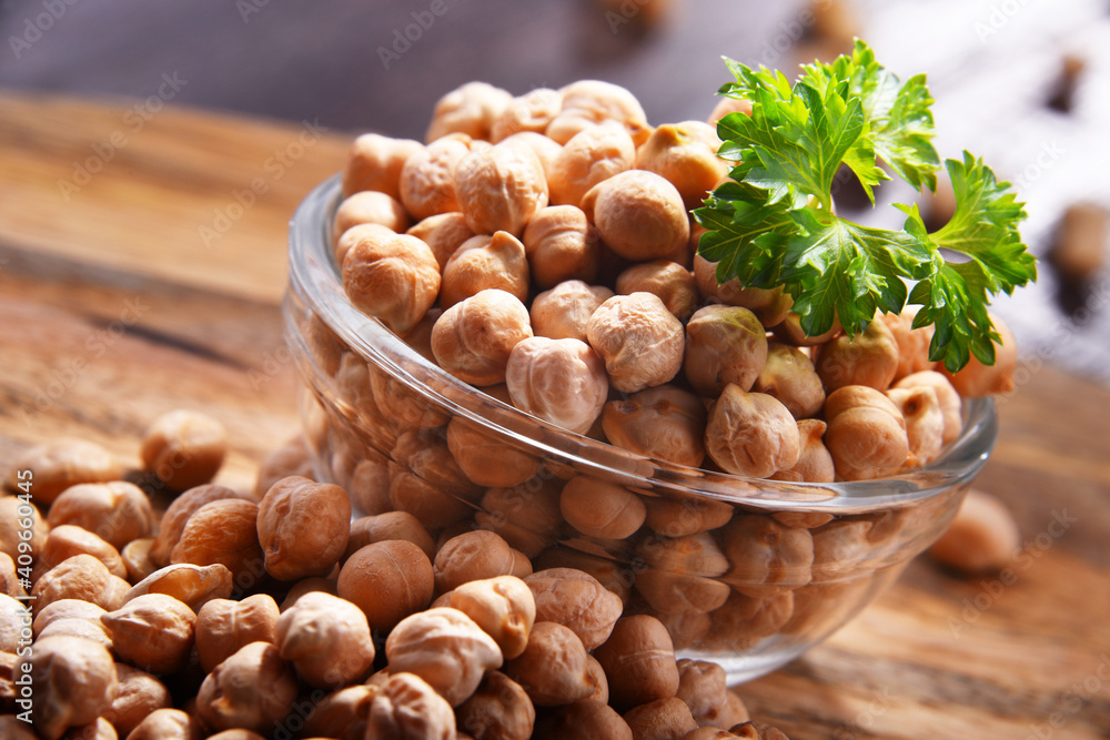 Composition with bowl of chickpeas on wooden table Composition with bowl of chickpeas on wooden table