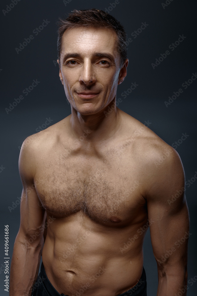 Fototapeta premium Male yoga with muscular body on grey background