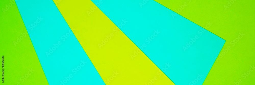 Abstract geometric composition. Yellow light blue green stripes of paper. Bright web banner. Colorful background with copy space for design. Stationery or spring summer concept.