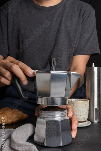 Photography preparing a barista using Italian moka pot coffee