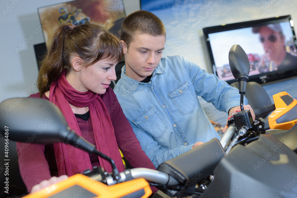 couple checking a new motorbike couple checking a new motorbike