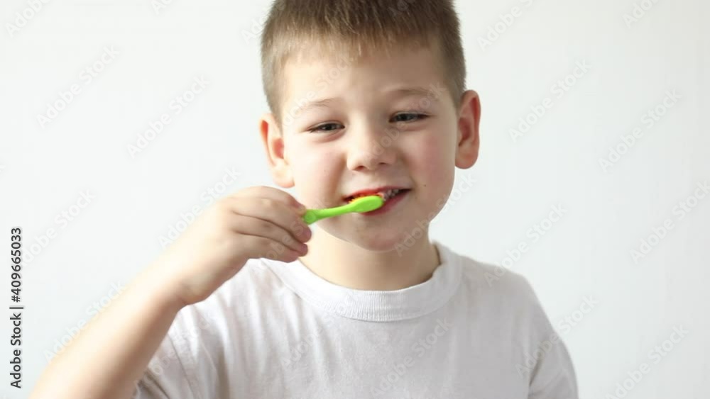 Young little kid boy brushing his teeth using tooth brush and oral paste, cleaning teeth. Learning dental education Young little kid boy brushing his teeth using tooth brush and oral paste, cleaning teeth. Learning dental education