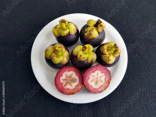 Mangosteen (Garcinia mangostana), also known as the purple mangosteen, is a tropical evergreen tree with edible fruit native to island nations of Southeast Asia and Thailand. Amazon, Brazil photo