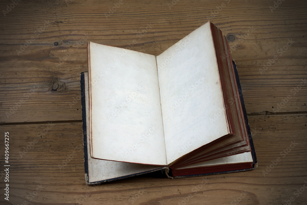 Fototapeta premium Old open book with blank pages on wood background 