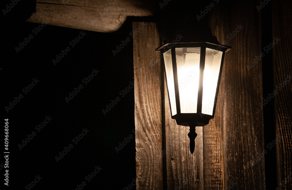 Lantern on a wooden wall