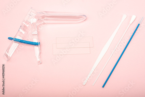 Disposable gynecological examination kit on a pink background. Gynecological examination set. The view from the top.