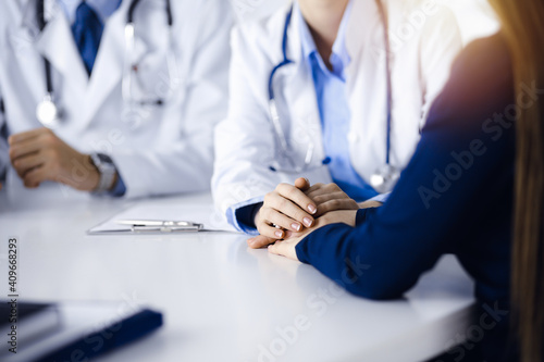 Unknown woman-doctor reassuring her female patient, close-up. Two physicians consulting and giving some advices to woman. Concepts of medical ethics and trust. Empathy in medicine