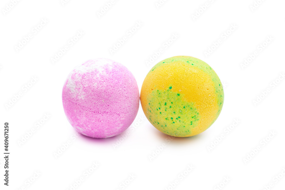Aroma yellow-green and pink bubbling round bright bath bombs isolated on a white background. Close-up of bath salts Aroma yellow-green and pink bubbling round bright bath bombs isolated on a white background. Close-up of bath salts