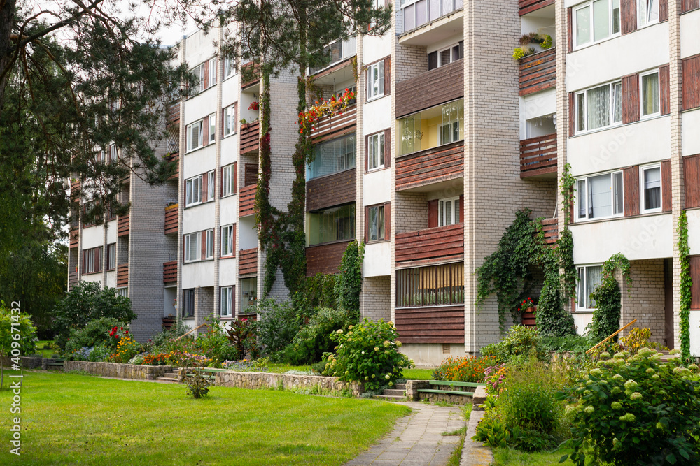 Four storey, residential block of flats house (Khrushchyovka) with cozy garden. Four storey, residential block of flats house (Khrushchyovka) with cozy garden.