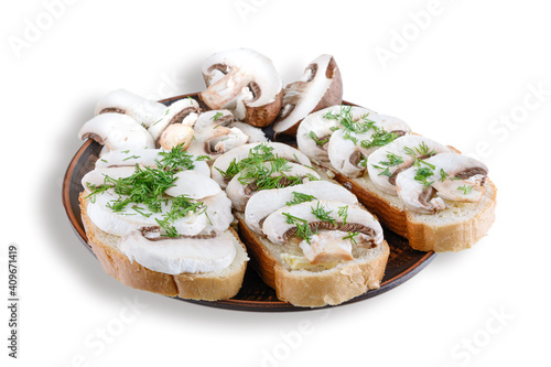 Sandwiches with raw mushrooms champignon and dill on a plate, white isolated background