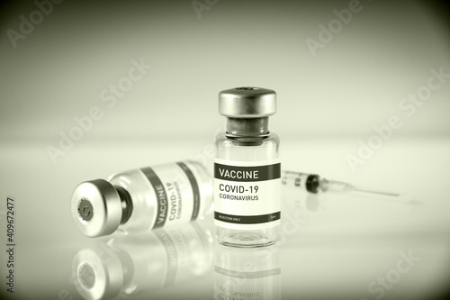 Covid-19 vaccine bottle and syringe on a black and white background