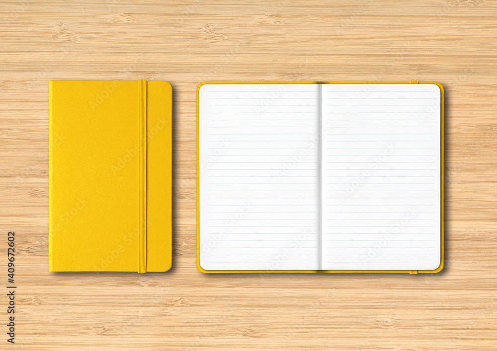 Yellow closed and open lined notebooks on wooden background Yellow closed and open lined notebooks on wooden background
