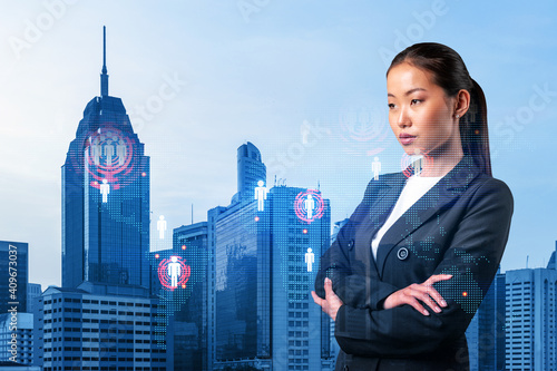 Canvas Print Attractive young Asian HR director at international company is thinking about recruitment of highly qualified specialists