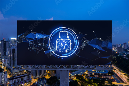 Canvas Print Padlock icon hologram on road billboard over panorama city view of Kuala Lumpur at night to protect business, Malaysia, Asia
