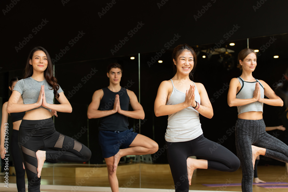 Yoga class of young people interested in yoga activities With a yoga teacher who helps teach yoga postures to students In order to be physically strong and flexible. Yoga class of young people interested in yoga activities With a yoga teacher who helps teach yoga postures to students In order to be physically strong and flexible.