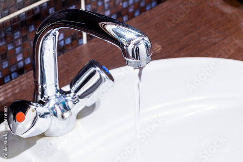 faucet at domestic bathroom with low water pressure. leaky tap repair