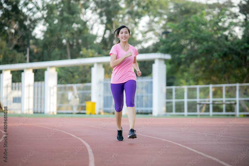 Asian women are running at the park to lose weight and stay healthy.