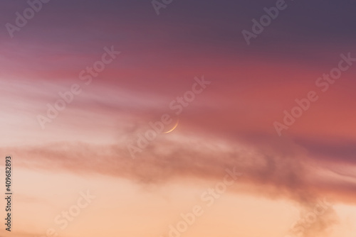 Obraz na płótnie New moon moon among pink clouds at sunset. w salonie