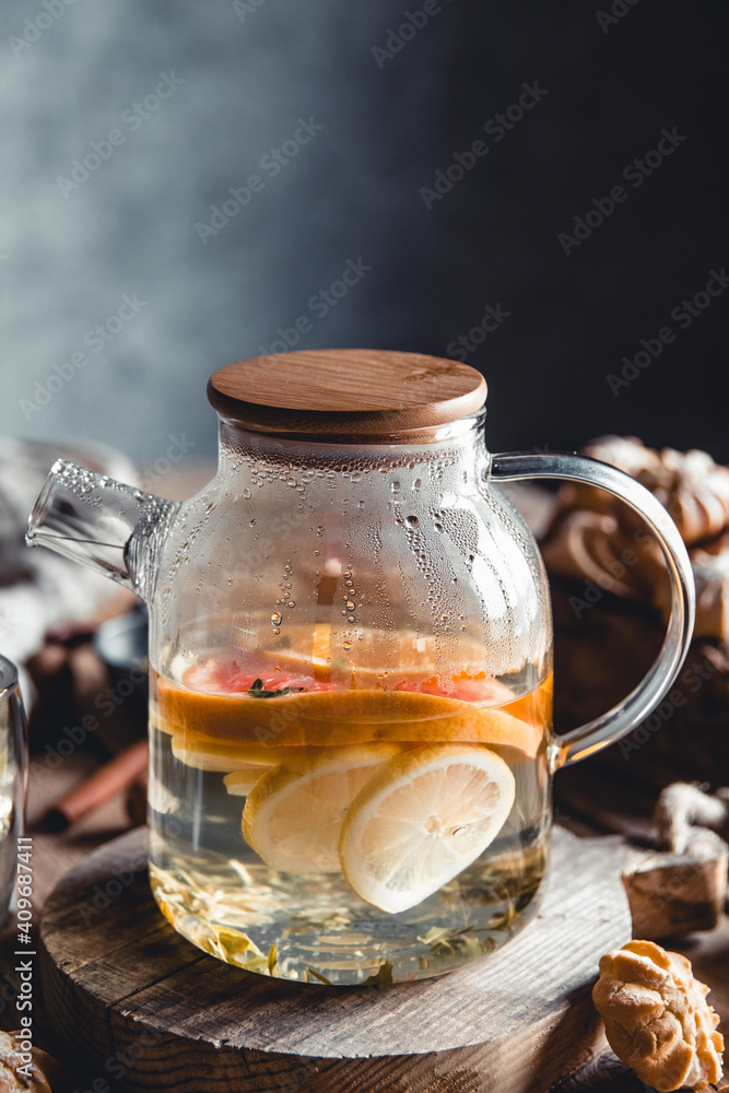 Hot tea with slices of fresh grapefruit on wooden tablet. Healthy drink, Eco, vegan Hot tea with slices of fresh grapefruit on wooden tablet. Healthy drink, Eco, vegan