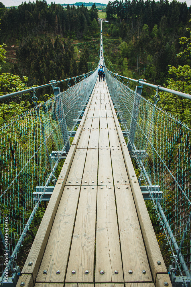 Geierlay Suspension Bridge in Hunsrück Mountain Range. It is the second longest suspension bridge in Germany and a famous tourist attraction. Geierlay Suspension Bridge in Hunsrück Mountain Range. It is the second longest suspension bridge in Germany and a famous tourist attraction.