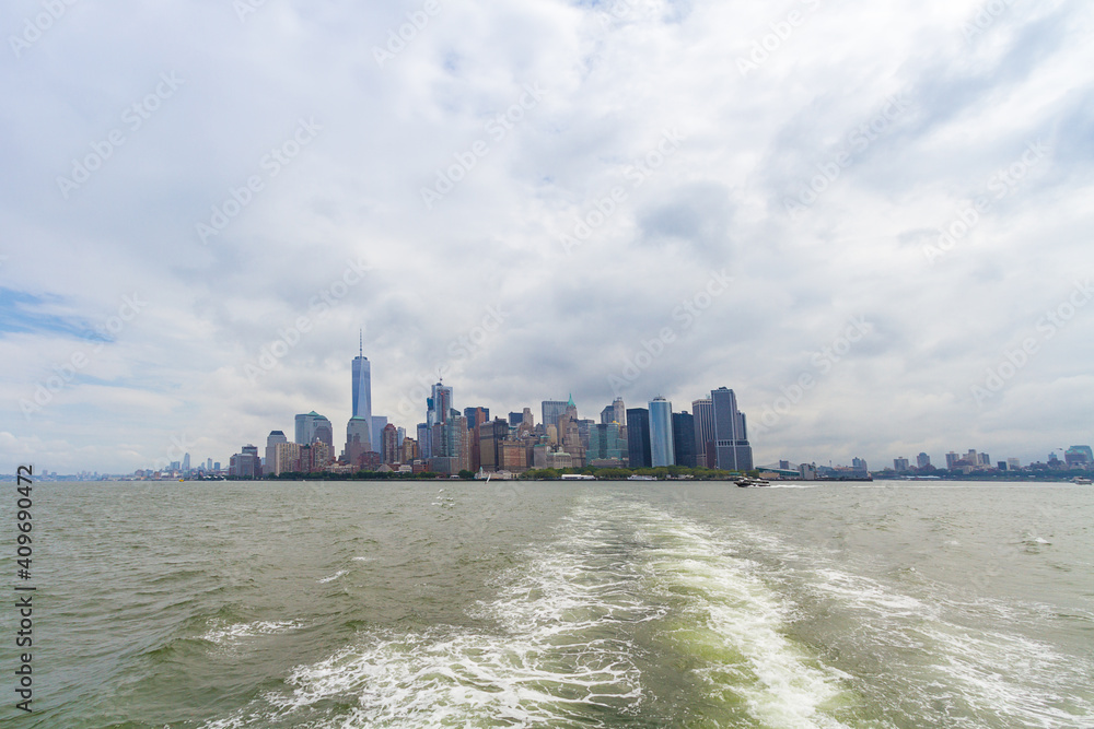 A ferry ride towards Manhattan skyline on a cloudy day