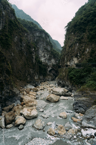 Stony river bed with epic steep cliffs on each side in Taroko National Park. © philip