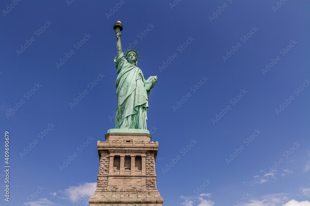 The Statue of Liberty on blue sky background under the sunshine