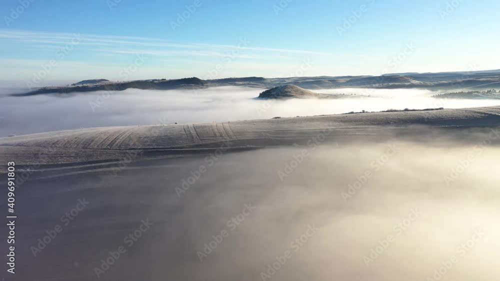 Flying over hills in mystic foggy winter morning. Aerial view by drone Flying over hills in mystic foggy winter morning. Aerial view by drone