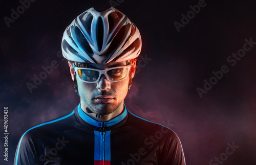 Fototapeta Naklejka Na Ścianę i Meble -  Spost background with copyspace. Cyclist. Dramatic colorful close-up portrait.