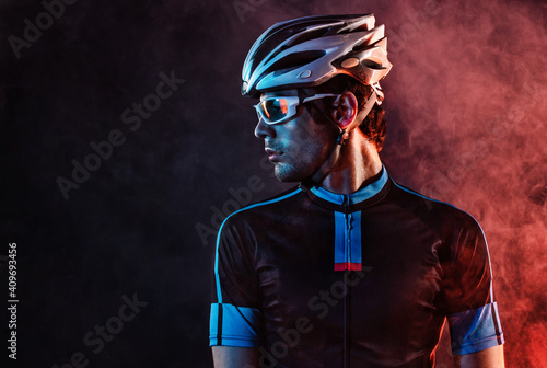 Fototapeta Naklejka Na Ścianę i Meble -  Spost background with copyspace. Cyclist. Dramatic colorful close-up portrait.