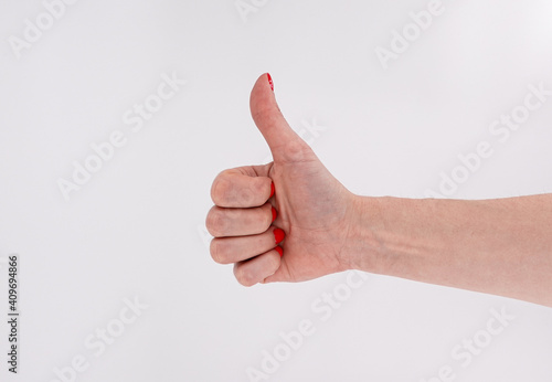 Female hand in a pose "like" on a background