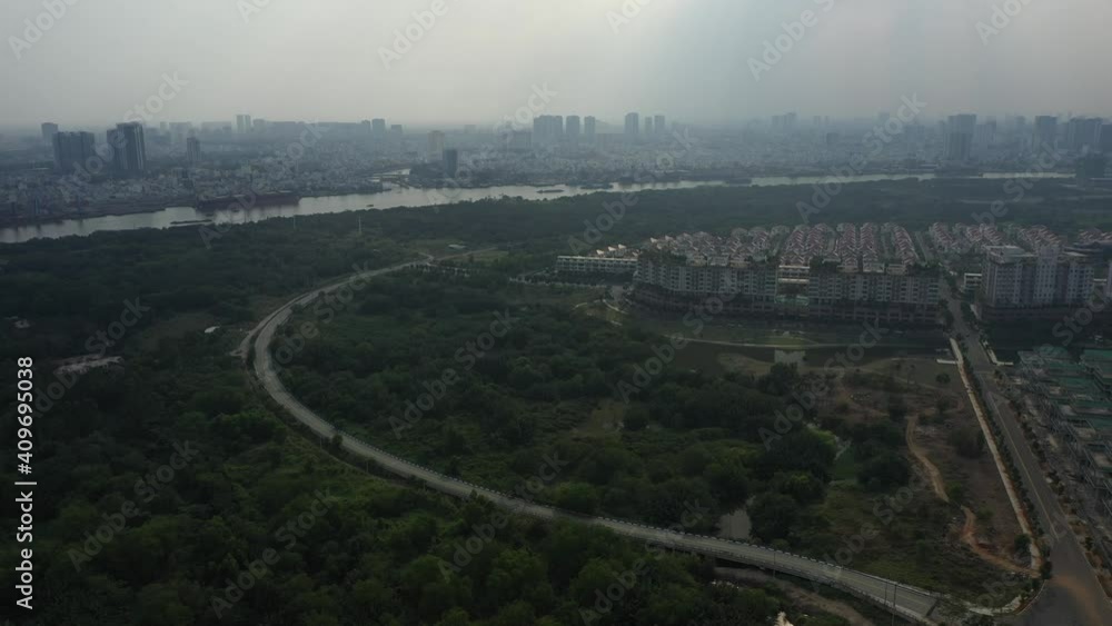aerial fly in to a new upmarket housing development on the Saigon River in Ho Chi Minh City, Vietnam. The development is surrounded by wetlands. aerial fly in to a new upmarket housing development on the Saigon River in Ho Chi Minh City, Vietnam. The development is surrounded by wetlands.