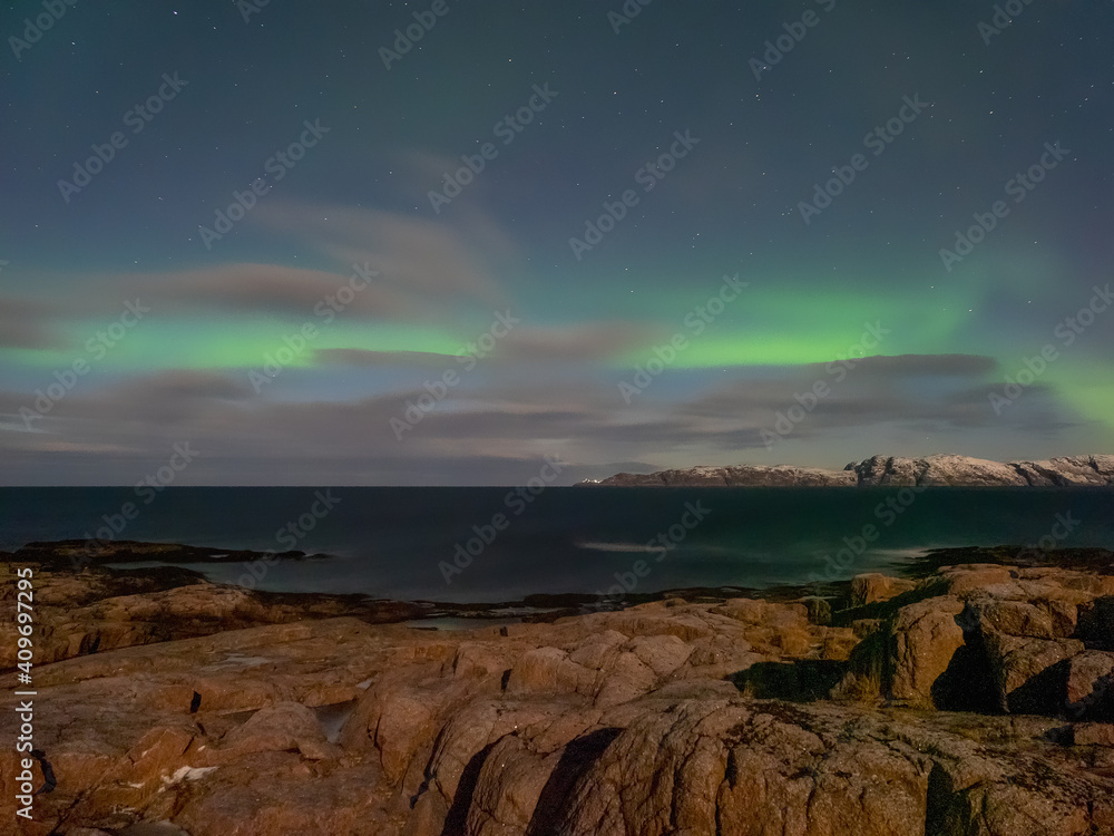 Evening polar landscape with the Aurora Borealis