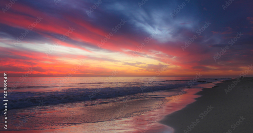 Sunset over a stormy California beach.