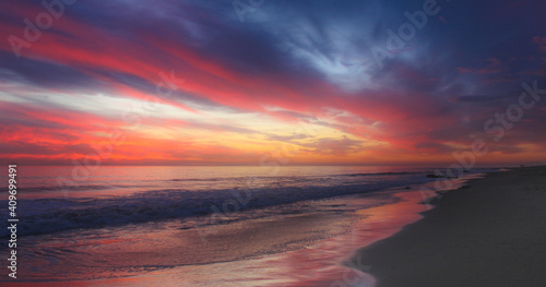 Sunset over a stormy California beach.