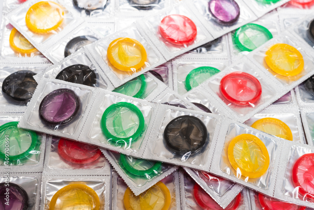 Colorful condoms background. Colorful condoms background.